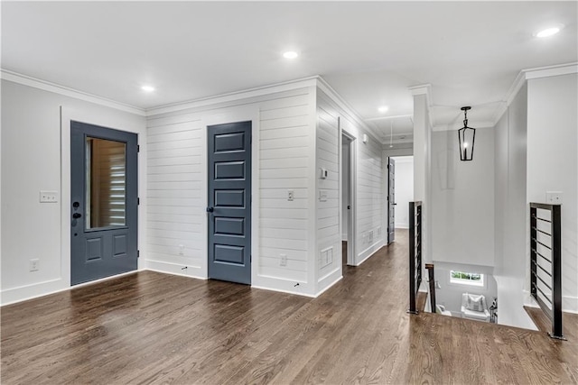 entryway featuring ornamental molding, wood walls, and dark hardwood / wood-style floors