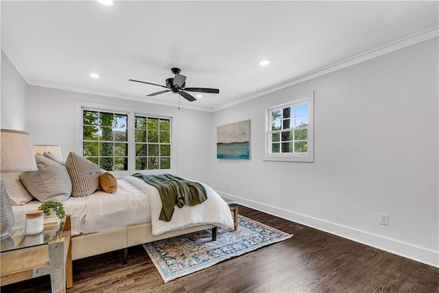 bedroom featuring ceiling fan, ornamental molding, and dark hardwood / wood-style flooring