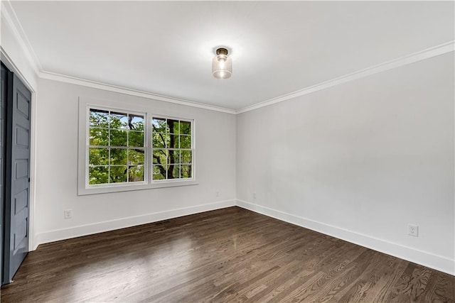 empty room with ornamental molding and dark wood-type flooring