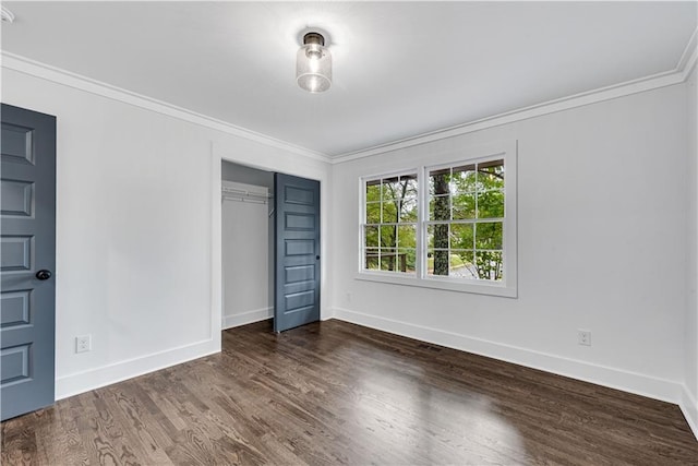 unfurnished bedroom with a closet, dark hardwood / wood-style floors, and ornamental molding