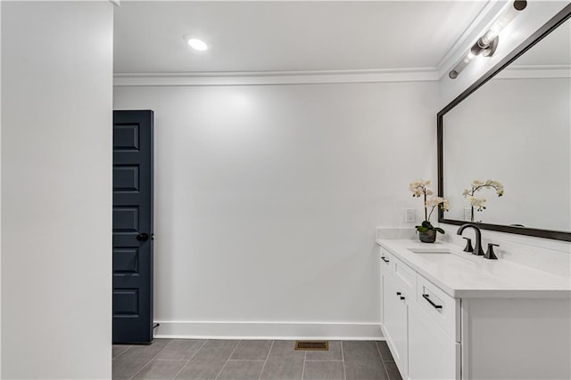 bathroom with crown molding and vanity