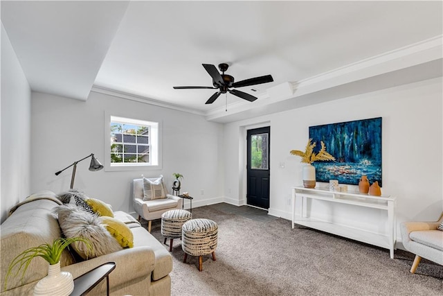 carpeted living room featuring ceiling fan, ornamental molding, and a wealth of natural light