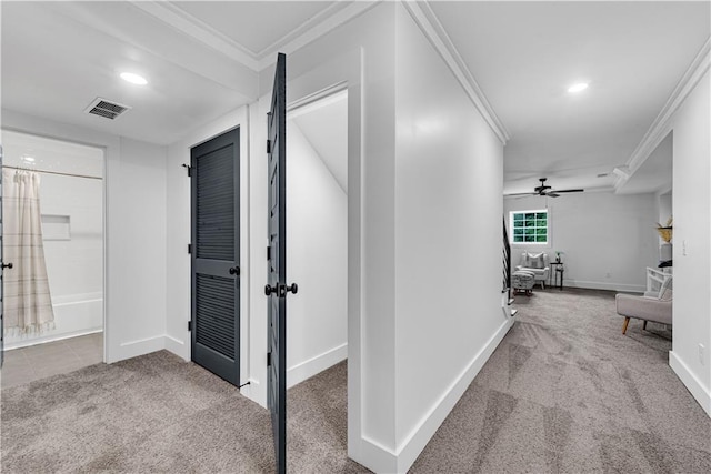 hall with crown molding and carpet flooring