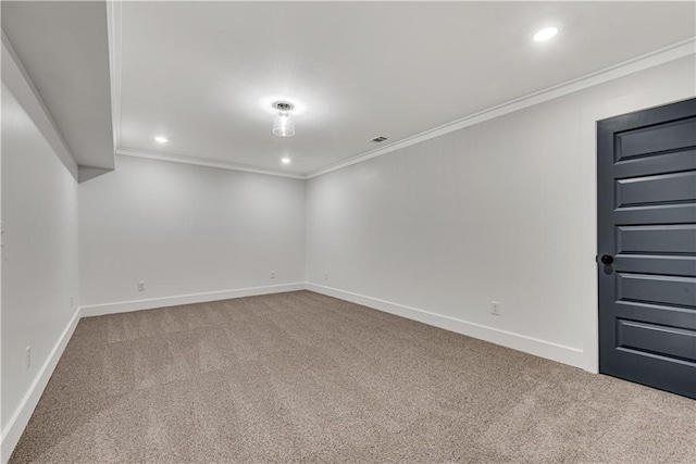 empty room with crown molding and carpet flooring