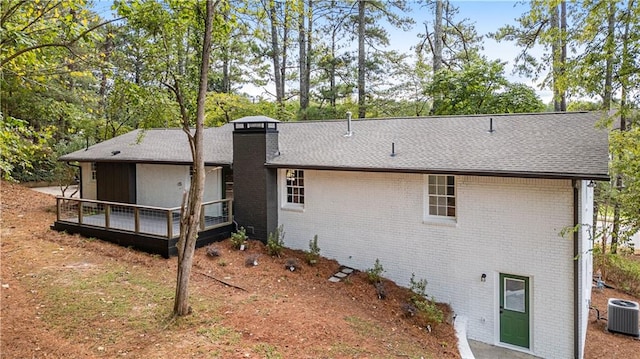 back of property featuring a deck and central air condition unit