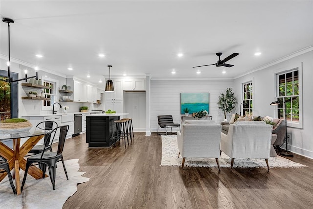 dining space featuring ceiling fan, dark wood-type flooring, and crown molding