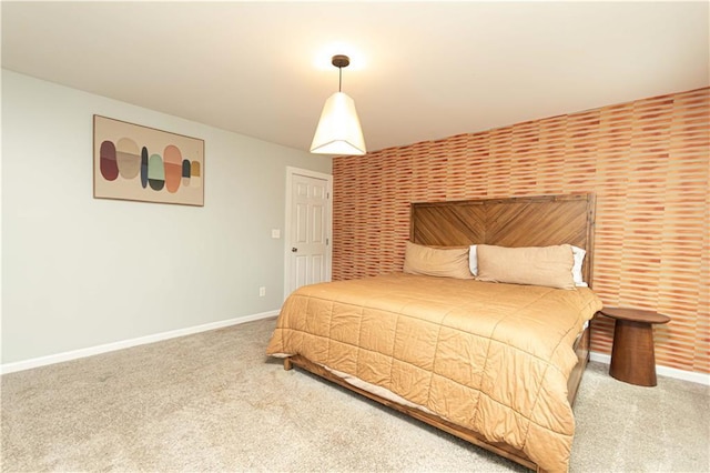 bedroom featuring baseboards and carpet