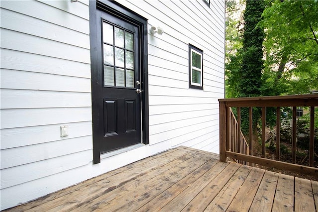 view of exterior entry with a wooden deck