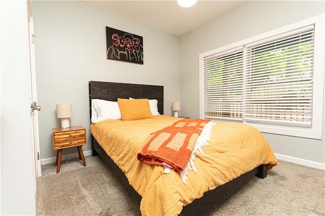 carpeted bedroom with baseboards