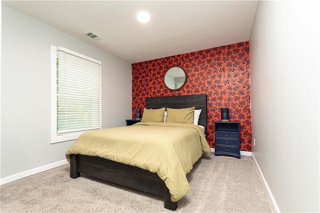 carpeted bedroom with visible vents and baseboards