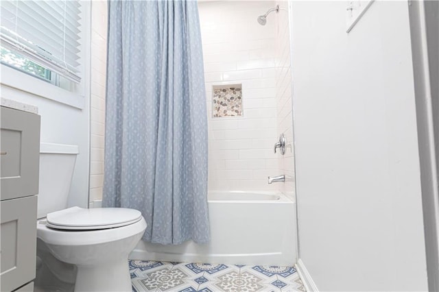 full bathroom featuring shower / bath combo with shower curtain, tile patterned flooring, and toilet