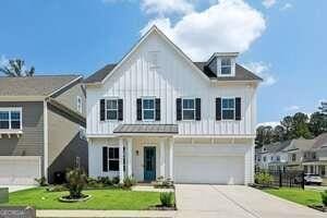 247 Widener Way, Peachtree City, GA 30269 - modern inspired farmhouse with board and batten siding, a garage, and driveway
