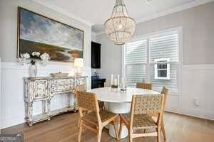 247 Widener Way, Peachtree City, GA 30269 - dining space with a chandelier, wood finished floors, and ornamental molding
