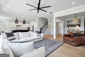 247 Widener Way, Peachtree City, GA 30269 - doorway with crown molding and light wood-style flooring
