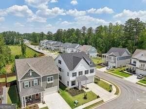 247 Widener Way, Peachtree City, GA 30269 - view of front facade featuring board and batten siding, an attached garage, and concrete driveway