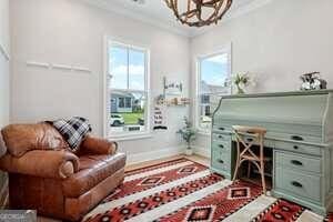 247 Widener Way, Peachtree City, GA 30269 - living area featuring ornamental molding, wood finished floors, and a brick fireplace