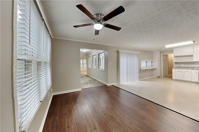 2041 Kramer Way, Marietta, GA 30062 - unfurnished living room featuring a ceiling fan, light wood-type flooring, a textured ceiling, baseboards, and ornamental molding