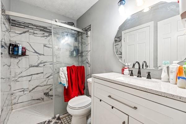 bathroom with walk in shower, vanity, and toilet