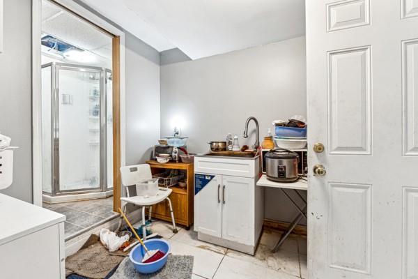 interior space featuring sink and white cabinets