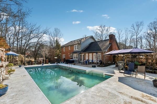 view of swimming pool with a patio area