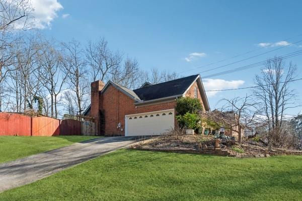 view of property exterior with a yard and a garage