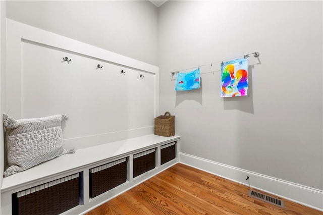 mudroom with baseboards, wood finished floors, and visible vents