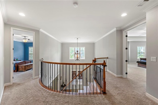 hall featuring carpet floors, baseboards, an upstairs landing, and visible vents