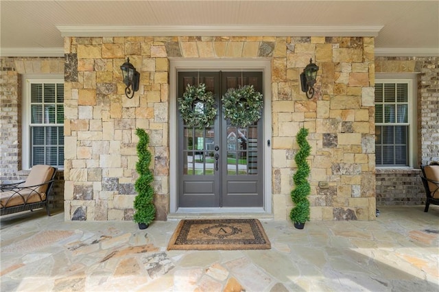 entrance to property featuring french doors and stone siding