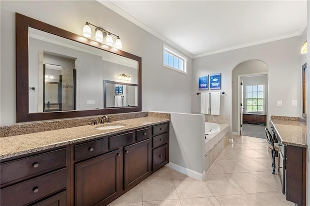 bathroom with crown molding, a bath, a wealth of natural light, and vanity