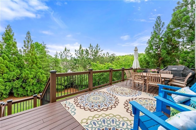 deck featuring outdoor dining space and a grill