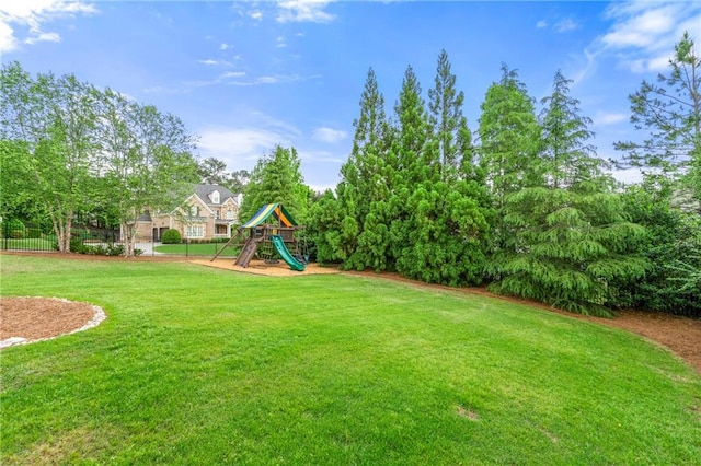 view of yard featuring fence and playground community