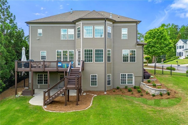 back of property with fence, stairs, a wooden deck, a patio, and a yard