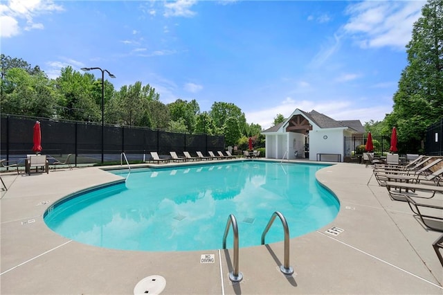 pool with fence and a patio area