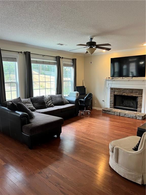 living room with a textured ceiling, a wealth of natural light, and hardwood / wood-style floors