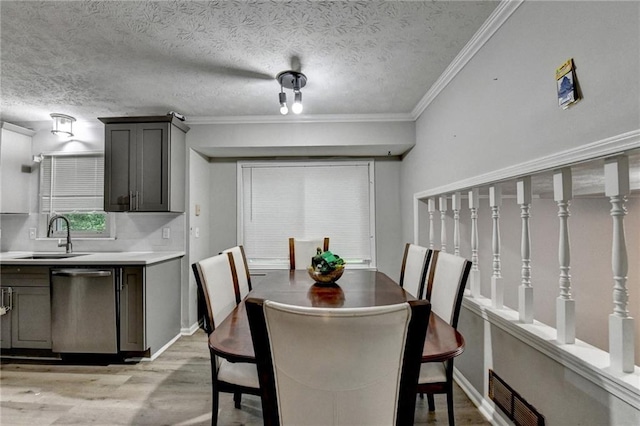 4444 Lisa Way NW, Lilburn, GA 30047 - dining room featuring light wood-style flooring, crown molding, and a textured ceiling
