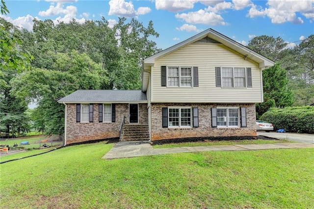 4444 Lisa Way NW, Lilburn, GA 30047 - tri-level home featuring a front yard and brick siding