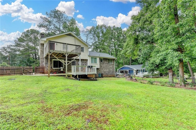 4444 Lisa Way NW, Lilburn, GA 30047 - rear view of house featuring a wooden deck, a chimney, and view of scattered trees