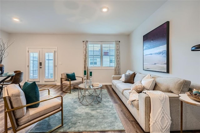 living room with french doors, hardwood / wood-style flooring, and plenty of natural light