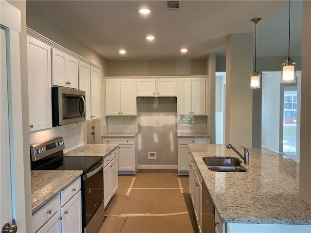 kitchen with sink, light stone counters, decorative light fixtures, white cabinets, and appliances with stainless steel finishes