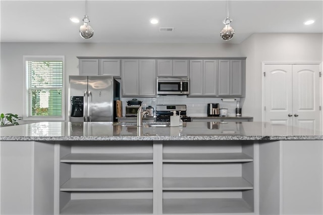 kitchen featuring open shelves, gray cabinetry, tasteful backsplash, and stainless steel appliances