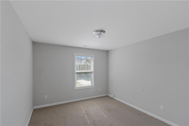 carpeted spare room with baseboards