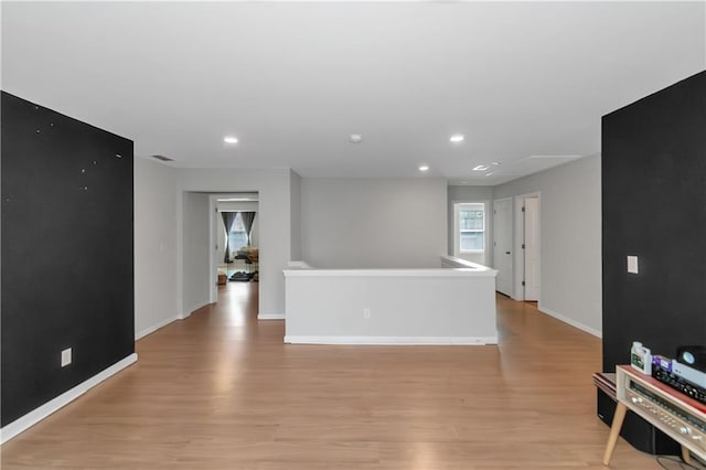 empty room with recessed lighting, light wood-type flooring, baseboards, and visible vents