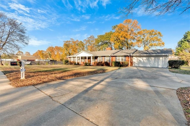 ranch-style house with a front lawn, driveway, fence, a garage, and a chimney