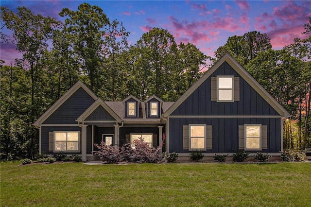 view of front of house with a front yard, board and batten siding, and covered porch