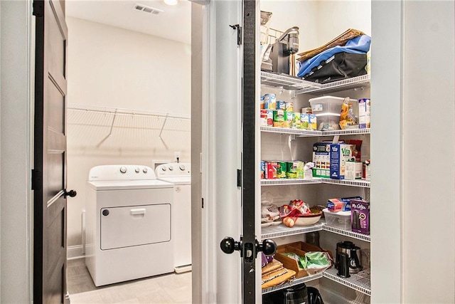 storage area with washing machine and clothes dryer