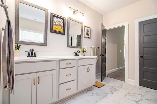 full bathroom with marble finish flooring, double vanity, and baseboards