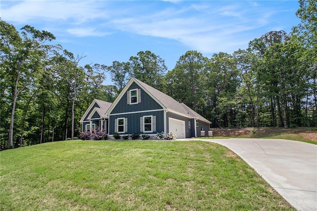 view of front of house with concrete driveway, an attached garage, a front yard, and board and batten siding