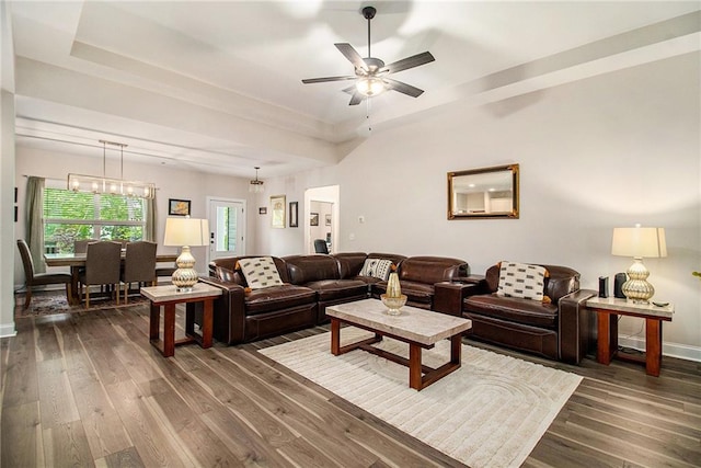 living room with dark wood finished floors, ceiling fan, and baseboards