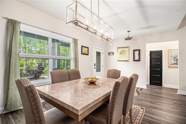 dining area featuring baseboards and dark wood-style floors