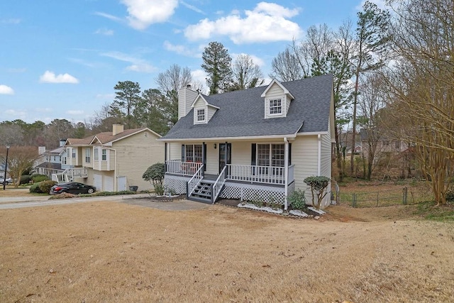 cape cod home featuring a chimney, a porch, a shingled roof, fence, and a front lawn